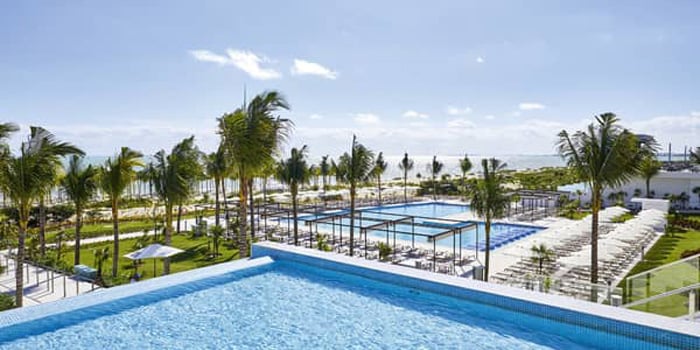 Pool and palm trees Riu Palace Costa Mujeres